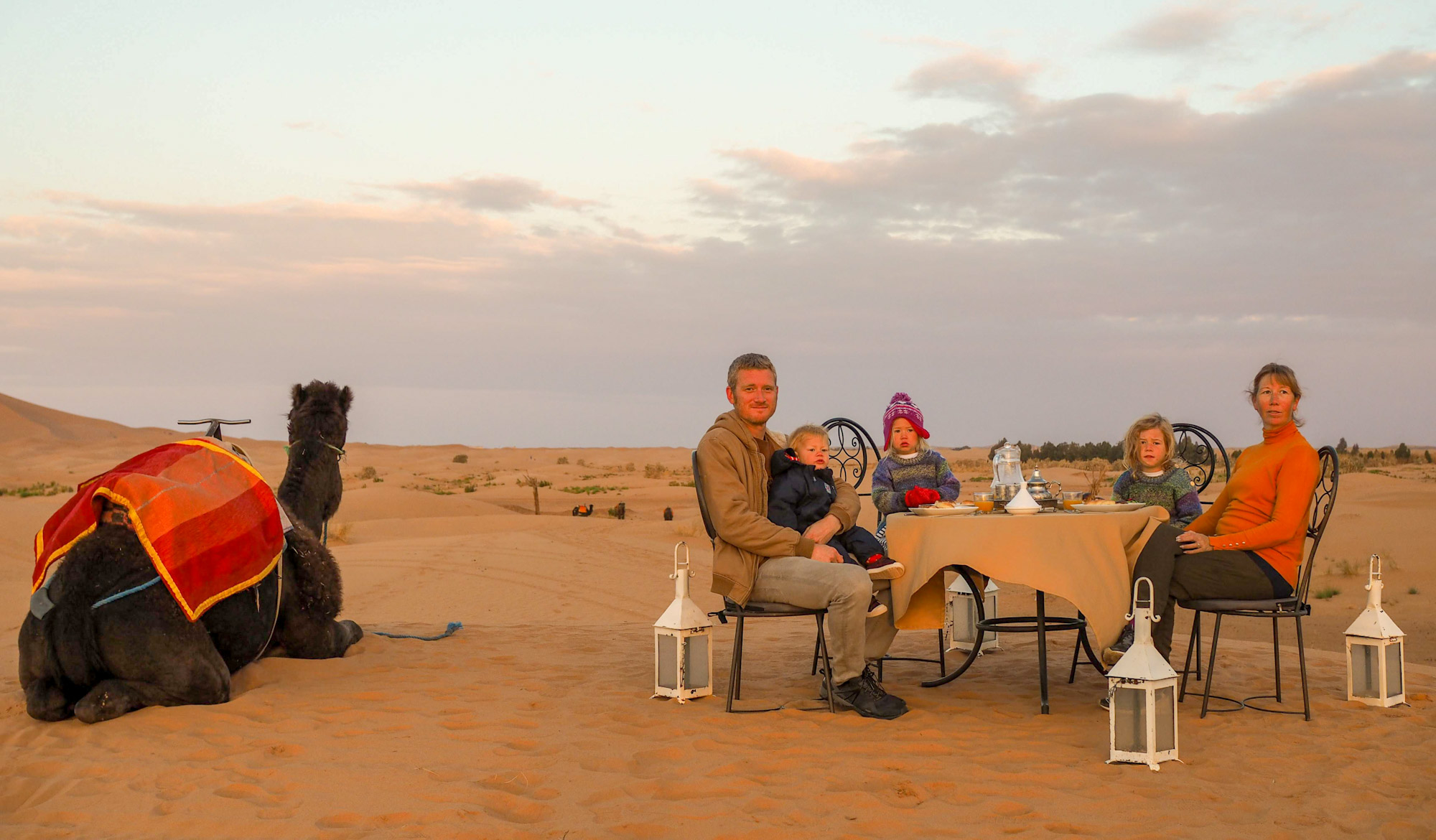Family eating breakfast at a Saharan desert camp