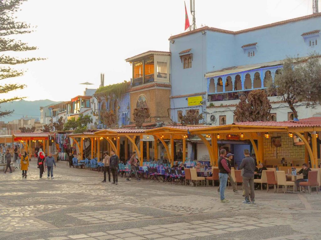 View of a line of restaurants, set along the side of the main pedestrianised square, in Chefchaoun, Morocco