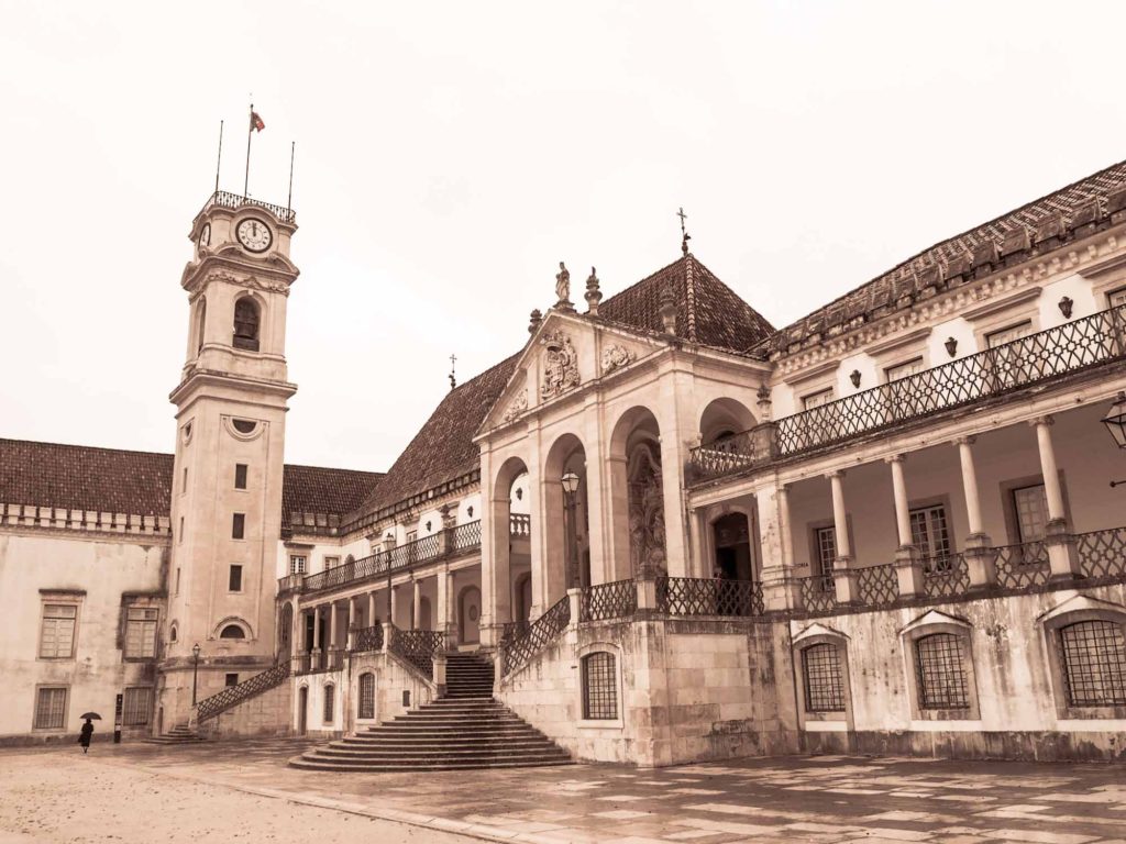 View of a grand old building with clock tower - part of University of Coimbra, Portugal