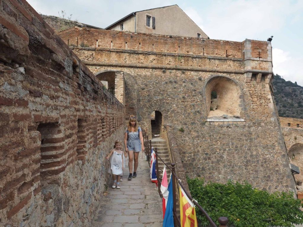 Family exploring the stone and brick ramparts at the Fort Liberia, Villefranche-de-Conflent