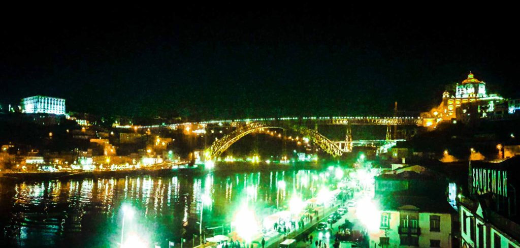 View of the river and Luis I Bridge lit up at night, in Porto