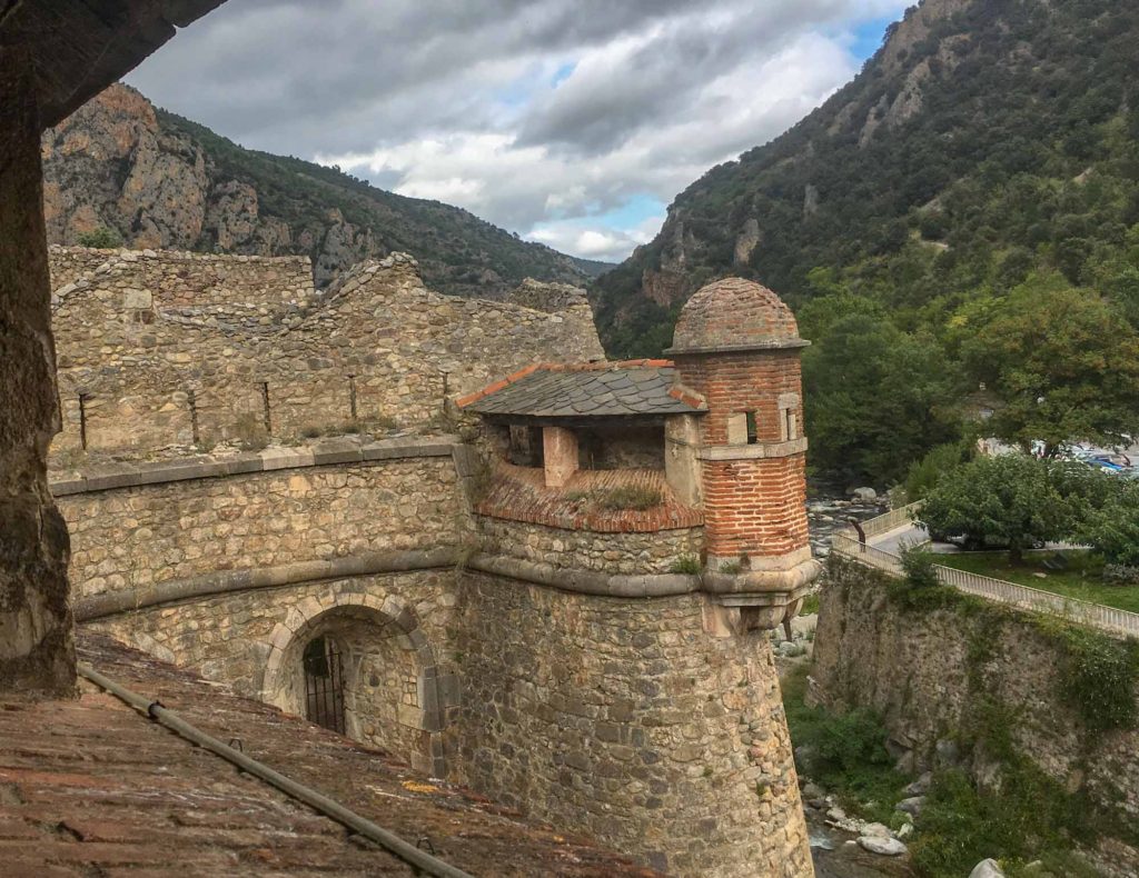 View of the stone and brick ramparts along the exterior wall at Villefranche-de-Conflent