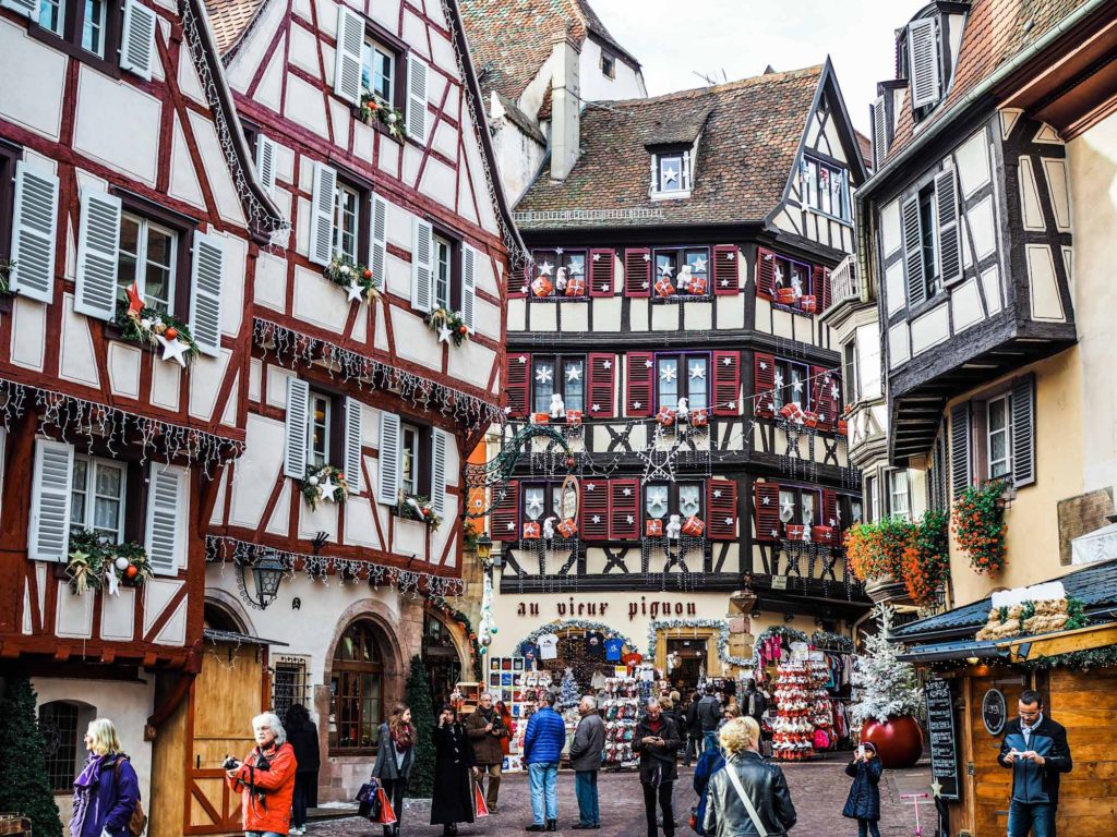 Germanic looking medieval half-timbered buildings decorated with Christmas lights and decorations