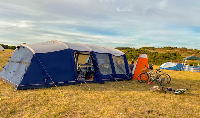 The outside of an Outwell Stonelake 7atc large family tent, pitched in a field