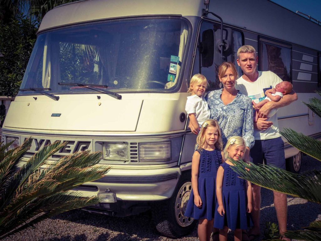 Family of 6 stood in front of their Classic Hymer motorhome