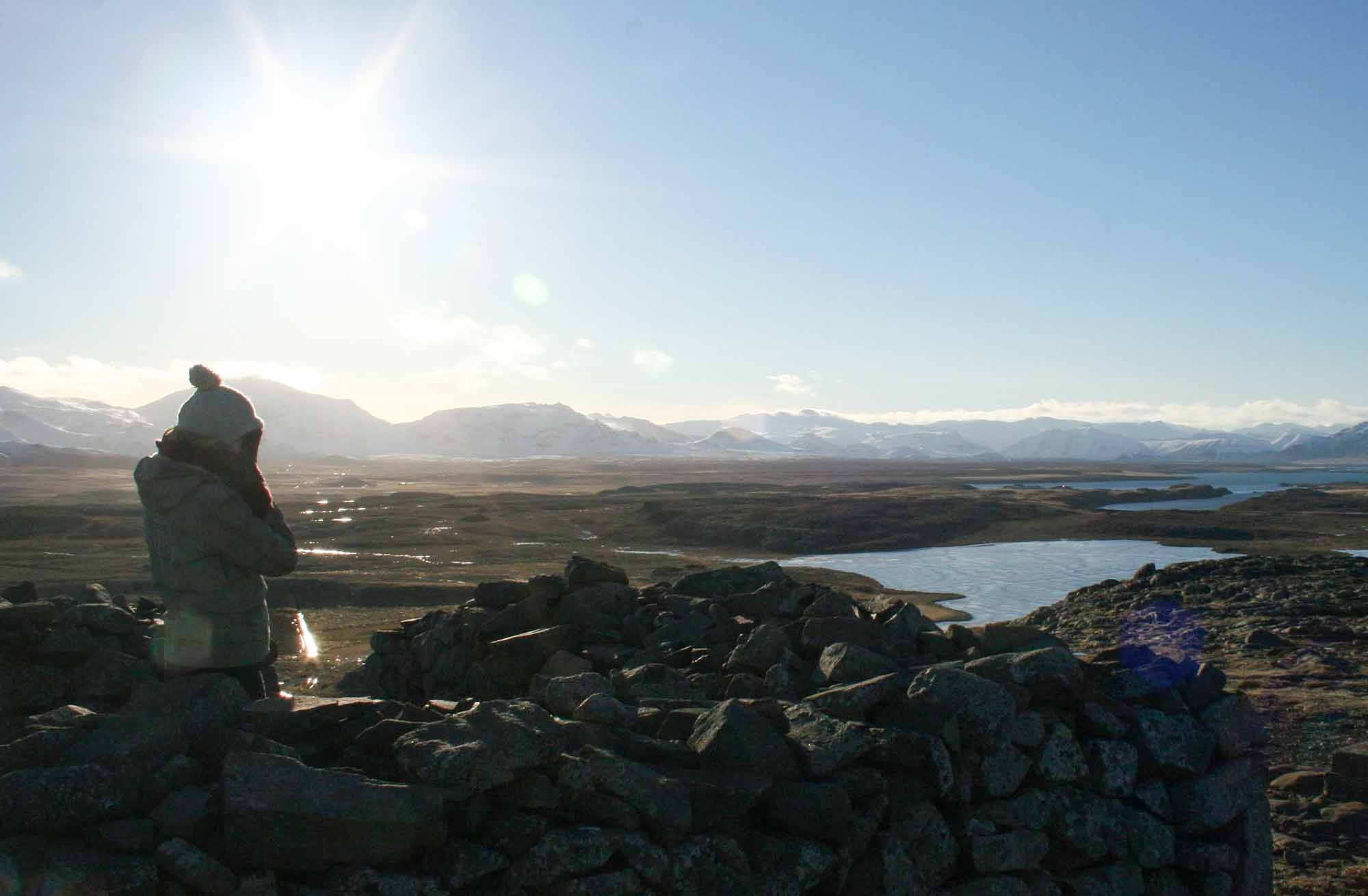 Lady stood at an expansive viewpoint of lakes and mountains in Iceland