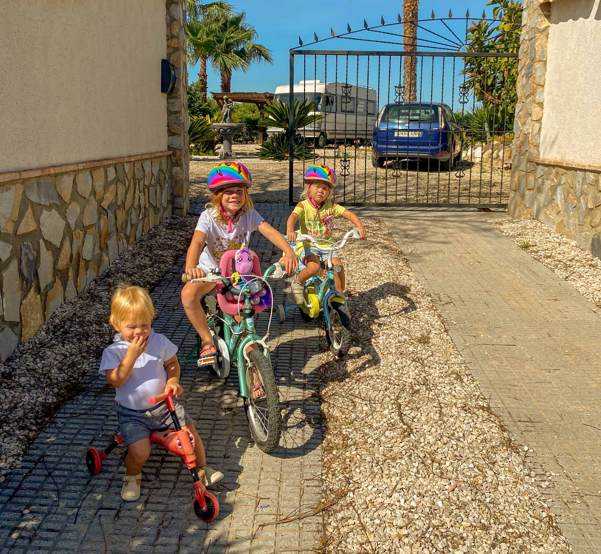 3 small children on their bikes ready for a ride