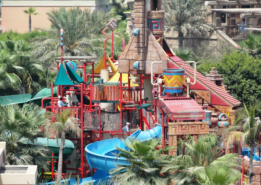 A jungle themed structure of water slides at a water park