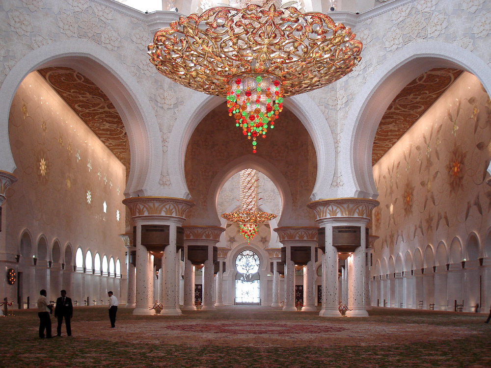 Inside the main prayer hall at the Abu Dhabi Grand Mosque, with large arch features and intricate decoration