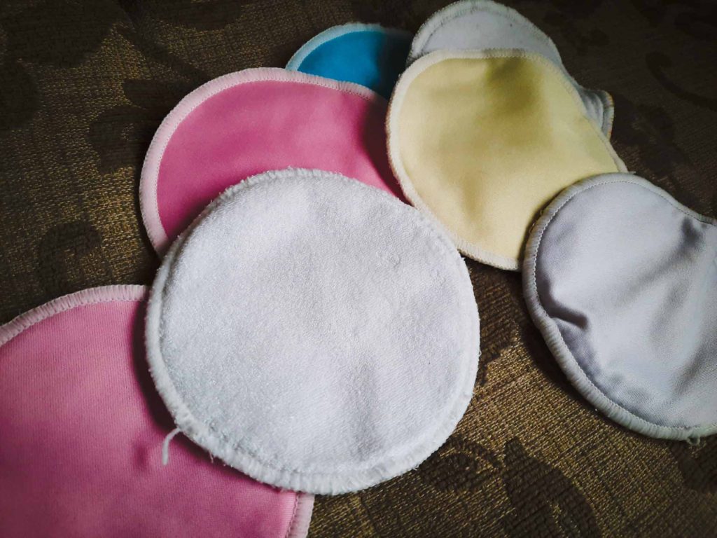 A scattering of reusable breast pads, used when breast feeding