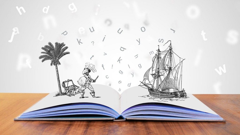 An open book on a table top with a cartoon line drawing of a pirate and pirate ship appearing to come out of the pages