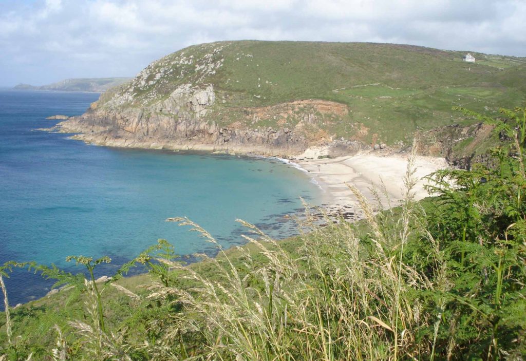 Clifftop viewpoint over a small, sandy bay