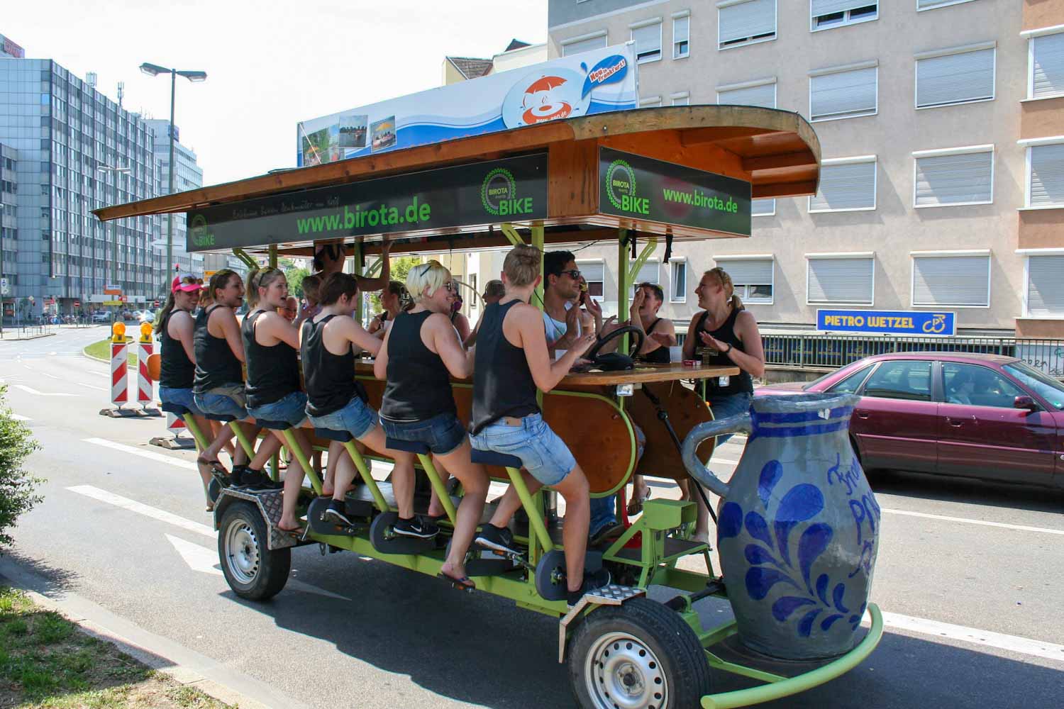 A mobile pedal-powered bar with a group of people sat around it