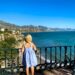 Small girl stood at a viewpoint overlooking the sea